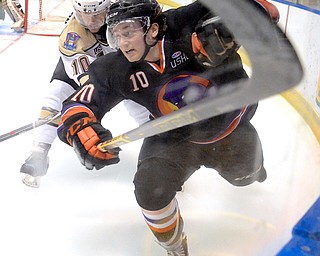 Jeff Lange | The Vindicator  APRIL 4, 2015 - Youngstown's Kevin Conley (right) is shoved into the boards by Muskegon's Trevor Hamilton (left) during second period action in their matchup at the Covelli Centre, Saturday night.