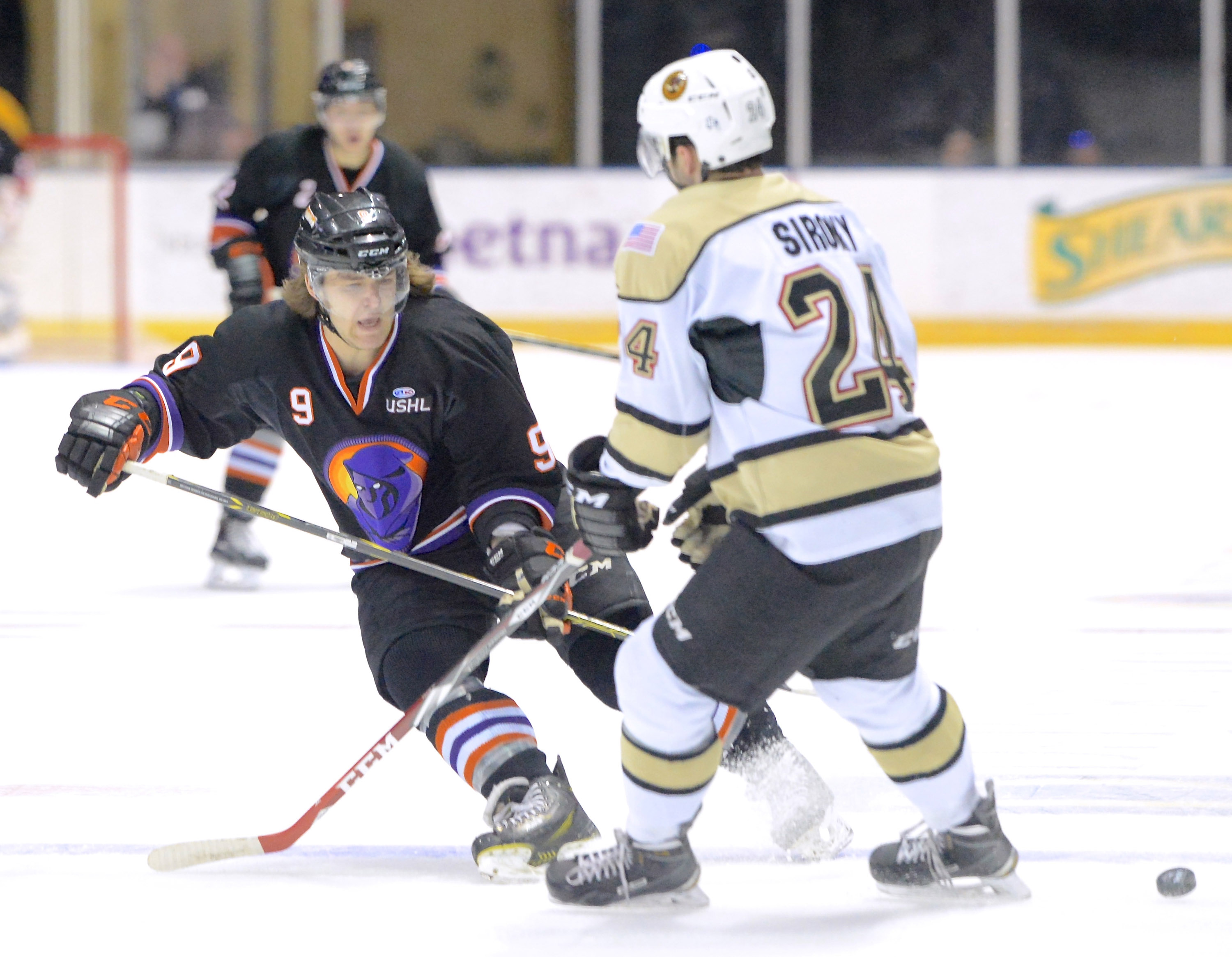 Jeff Lange | The Vindicator  APRIL 4, 2015 - Youngstown's Taylor Best (9) passes the puck to a teammate around the defense of Lumberjacks' Ryan Siroky in the second period of the Phantoms' game, Saturday night at the Covelli.
