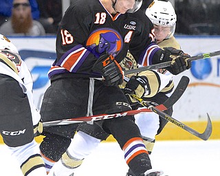 Jeff Lange | The Vindicator  APRIL 4, 2015 - Youngstown's Kyle Connor (18) is tripped up by Muskegon's Juraj Mily (left) and Bo Hanson (right) in the first period of the Phantoms' game, Saturday night in Youngstown.