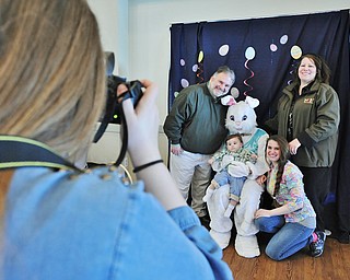 Jeff Lange | The Vindicator  APRIL 4, 2015 - Mark and Lori Detwiler of Boardman (back left and right) pose for a family portrait with the Easter Bunny, daughter Sunny Osman (bottom right) and grandson Emmitt Osman 13 months old (bottom left), Saturday morning during the Easter festivities at Mill Creek MetroParks Farm in Canfield. Taking the photograph is Sasha Detwiler.