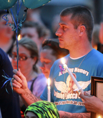 William D Lewis The vindicator Ethan gump, father of fire victim Corinne Gump holds a candle during a 4-7-15 vigil at house where 3 people died in a house fire.