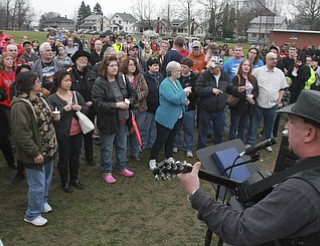 William D Lewis The vindicator Eddie Berg of Yougstown plays a song he wrote about fire victim Corinne Gump duirng a Tuesday vigil for Corrine and her grandparents who were killed in a house fire on Powersway. Several hundred people attended the event.