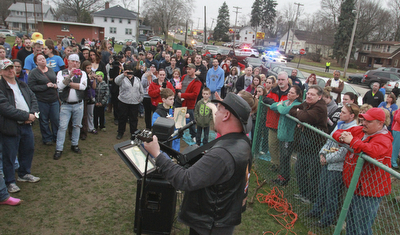 William D Lewis The vindicator Eddie Berg of Yougstown plays a song he wrote about fire victim Corinne Gump duirng a Tuesday vigil for Corrine and her grandparents who were killed in a house fire on Powersway. Several hundred people attended the event.