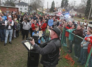 William D Lewis The vindicator Eddie Berg of Yougstown plays a song he wrote about fire victim Corinne Gump duirng a Tuesday vigil for Corrine and her grandparents who were killed in a house fire on Powersway. Several hundred people attended the event.