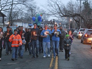William D Lewis The vindicator Friends and family of 3 people killed in a house fire walk down Powersway in Youngstown during a 4-7-15 vigil for the victims.