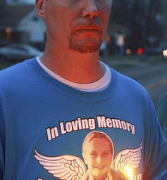 William D Lewis The vindicator Patrick Hagerty of Youngstown, a family friend of those killed in housefire help organize a 4-7-5 vigil.
