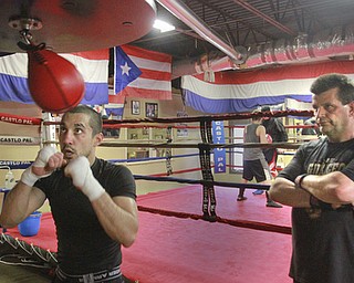 William D. Lewis The Vindicator Jake Giuriceo trains at Burnside Boxing in Struthers 4-6-15. Looking on is trainer Keith Burnside.