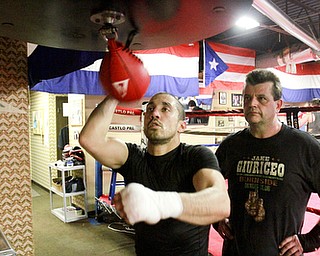 William D. Lewis The Vindicator Jake Giuriceo trains at Burnside Boxing in Struthers 4-6-15. Looking on is trainer Keith Burnside.