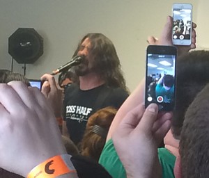 Kalea Hall | The Vindicator.Foo Fighters front man Dave Grohl performed for 150 fans at the Pine Tree Place Shopping Center on April 18, 2015.