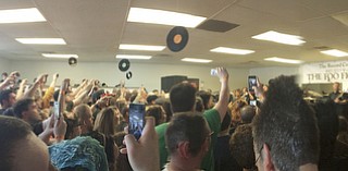 Katie Rickman | The Vindicator .In this panoramic photo fans throw their hands in the air, some taking photos and/or videos as Foo Fighters performed at the Pine Tree Place Shopping Center in Niles on April 18, 2015.