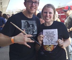 Katie Rickman | The Vindicator.Shala and Dan Kearsey of Ravenna smile as they hold up their concert mementos after the Foo Fighters concert at the Pine Tree Place Shopping Center in Niles on April 18, 2015. The couple took home a drum stick, set list and guitar picks.