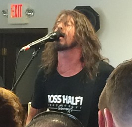 Katie Rickman | The Vindicator .Foo Fighters front man Dave Grohl performs a cover of Kids In America at the Pine Tree Place Shopping Center in Niles right down the plaza from The Record Connection.  The Foo Fighters performed in honor of National Record Store Day.