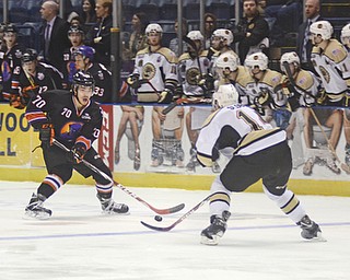 Katie Rickman | The Vindicator .Phantom's Ryan Lomberg (#70) looks for an open pass as he is guarded by Lumberjack's Adrian Sloboda (#14) during the first period of the game at the Covelli Centre on April 18, 2015.