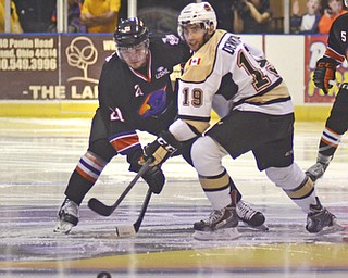 Katie Rickman | The Vindicator.Lumberjacks Robbie DeMontis (#19) looks on after  Phantoms Tyler Sheehy (#21) passes the puck during the first period of the game at the Covelli Centre on April 18, 2015.
