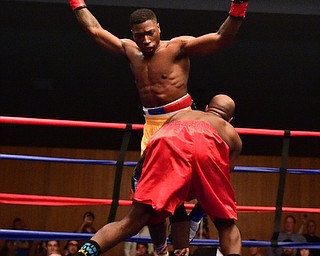 CAMPBELL, OHIO - APRIL 18, 2015: Victor Toney puts his arms up after avoiding a lunging punch of Dion Medows during a 153b bout Saturday night. (Photo by David Dermer/Youngstown Vindicator)