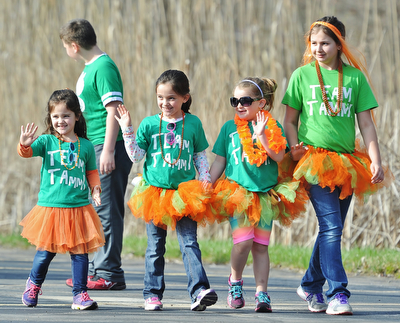 Jeff Lange | The Vindicator  APRIL 18, 2015 - Allison Altstaetter (5 far left), Lily Altstaetter (8 middle left), Kinsey Rednock (6 middle right) and Gentry Simmons (11 far right) walk together in the MS walk held at Eastwood Field in Niles. Allison and Lily are the daughters of April and Jake Altstaetter. Kinsey Rednock is the daughter of Lindsey Simmons. Gentry Simmons is the daughter of Bruce and Barbe Simmons.