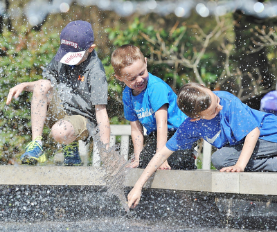 Jeff Lange | The Vindicator  APRIL 18, 2015 - Carson Gross, age 7 (left) of Columbiana, Vincent Polkovitch, age 4 (center), and Dominic Polkovitch, age 7, of Canfield cool off by playing in the fountain as they wait for the helicopter to arrive, Saturday morning.at Fellows Riverside Gardens in Youngstown during the 9th annual Children's Book Festival. Vincent and Dominic are the sons of Jen Polkovitch and Carson is the son of Andrea Gross.