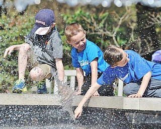 Jeff Lange | The Vindicator  APRIL 18, 2015 - Carson Gross, age 7 (left) of Columbiana, Vincent Polkovitch, age 4 (center), and Dominic Polkovitch, age 7, of Canfield cool off by playing in the fountain as they wait for the helicopter to arrive, Saturday morning.at Fellows Riverside Gardens in Youngstown during the 9th annual Children's Book Festival. Vincent and Dominic are the sons of Jen Polkovitch and Carson is the son of Andrea Gross.