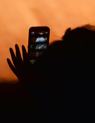 Katie Rickman | The Vindicator.A sillouette of a woman is shown here as she snaps a cellphone picture of Lawrence Brownlee as he performed selections from his CD "Spiritiual Sketches" at the DeYor Performing Arts Centre on April 19, 2015.