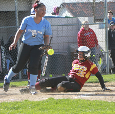 William d Lewis The Vindicator  Mooney's Julie Cook25) is safe as EastsJaela Howell(14) misses the throw at home duirng 4-21 game at Field of Dreams.