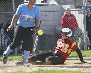 William d Lewis The Vindicator  Mooney's Julie Cook25) is safe as EastsJaela Howell(14) misses the throw at home duirng 4-21 game at Field of Dreams.