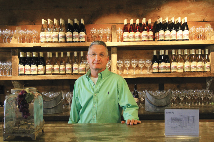 Randy Wyand stands behind the bar at Hartford Hill Winery in Trumbull County. Wyand and his wife, Carolyn, own the winery, which they constructed from two 19th-century barns that were disassembled, restored and combined to create a stately, rustic setting.
