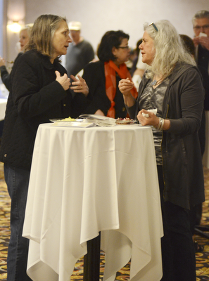Katie Rickman | The Vindicator.Elizabeth Arduin of Boardman on left talks with Samie Winick of Salem over various foods at the Memorable Meals Mahoning Valley at the Stambaugh Auditorium on April 26, 2015.
