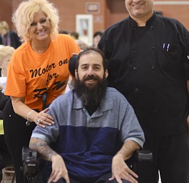 Katie Rickman | The Vindicator.Roslyn Schmidt, on left, Robert J. Melone, and Sean Kushma pose for a photo at the benefit for Melone who was paralyzed in a motorcycle accident...many family members and friends attended the benefit at St. Charles Hall in Boardman on April 26, 2015.