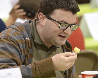 Katie Rickman | The Vindicator.Brad Gamlin enjoys food at the benefit for Robert J. Melone at St. Charles Hall in Boardman on April 26, 2015.