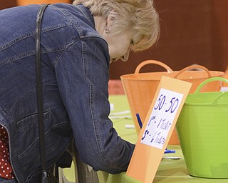 Katie Rickman | The Vindicator.Deb Hammond of Canfield fills out a ticket for the 50/50 drawing during a benefit for Robert J. Melone at St. Charles Hall in Boardman on April 26, 2015. Melone was paralyzed in a motorcycle accident.