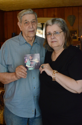 Donald LoGiudice and his ex-wife, Lorie LoGiudice,  embrace as they hold a photo of their son Donny who overdosed on heroin earlier this month at the age of 28.  