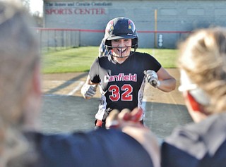 Jeff Lange | The Vindicator  APRIL 29, 2015 - Canfield senior Kara Rothbauer is all smiles as she hops onto home plate after hitting a 3-run homer in the 6th inning against Champion, Wednesday evening in Canfield. Rothbauer's home run made the score 9-5.