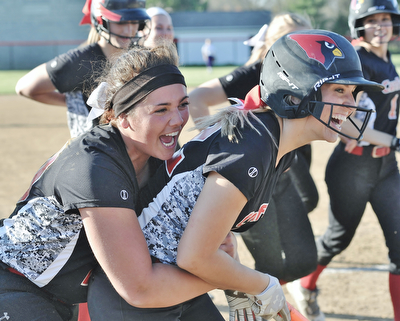Jeff Lange | The Vindicator  APRIL 29, 2015 - Canfield seniors Allison Fabry (left) and Kara Rothbauer celebrate Rothbauer's 3-run homer which made the score 9-5 in the sixth inning against Champion, Wednesday night at Canfield.