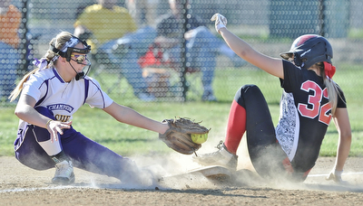Jeff Lange | The Vindicator  APRIL 29, 2015 - Canfield's Kara Rothbauer (32) slides safely into third under the tag of Champion's third baseman Brittany Allen in the bottom of the third inning of their softball game at Canfield High School, Wednesday night.