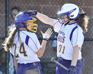 Jeff Lange | The Vindicator  APRIL 29, 2015 - Champion's Jackie Mulvain (right) congratulates Alexandra Steigerwald after crossing the plate in the top of the fourth inning of Wednesday night's game in Canfield.