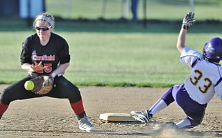 Jeff Lange | The Vindicator  APRIL 29, 2015 - Canfield shortstop Rachel Tinkey catches the throw from home as Champion base runner Carissa Hurst slides safely into second in the seventh inning of their softball game, Wednesday at Canfield High School.