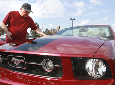 William d Lewis The Vindicator  Mario Iacone of Austintown checks out one of the Mustangs on display sunday at Quaker Steak and Lube in Austintown.