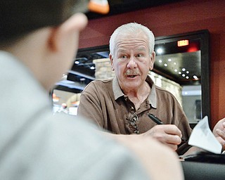 Jeff Lange | The Vindicator  APRIL 25, 2015 - Member of the 1980 Cleveland Browns, Don Cockroft signs an autograph for a young Cleveland fan during Saturday's meet and greet at Firebirds Grill in Niles.