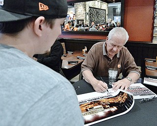 Jeff Lange | The Vindicator  APRIL 25, 2015 - Kicker for the 1980 Cleveland Browns Don Cockroft (right) signs a poster of the old Cleveland Municipal Stadium, site of the first Monday Night Football game in 1970 for Anthony Goett of Warren, Saturday afternoon at Firebirds Grill in Niles.