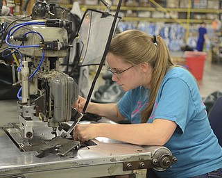 Katie Rickman | The Vindicator.Amy Jessop rethreads the joining machine GLI Pool Products in Youngstown on May 5, 2015.