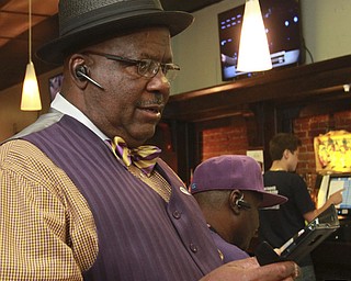 William D Lewis the Vindicator  Mike Write 1rst ward Youngstown c-man, checks results at Avalon Downtown election night.