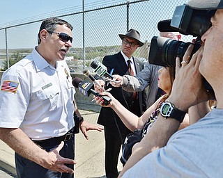 Jeff Lange | The Vindicator  MAY 4, 2015 - Battalion Chief Gary DiTullio (left) addresses the media about the chlorine leak, Monday morning in Youngstown.