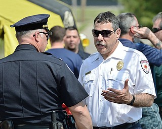 Jeff Lange | The Vindicator  MAY 4, 2015 - Battalion Chief Gary DiTullio (right) talks with a police officer just outside of the waste water treatment plant in Youngstown after a chlorine leak, Monday morning.