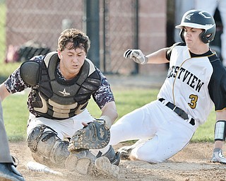 Jeff Lange | The Vindicator  MAY 6, 2015 - Crestview's Tyler Fitzsimmons (3) slides safely into home as South Range catcher Ryan Miller scrambles for the ball in the top of the sixth inning, Wednesday night at South Range High School.