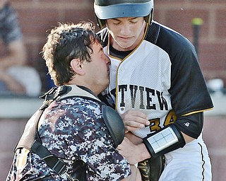 Jeff Lange | The Vindicator  MAY 6, 2015 - South Range catcher Ryan Miller slams his face into Crestview base runner Daniel Moore as he tags him out in the top of the seventh inning of Wednesday night's game at South Range High School.