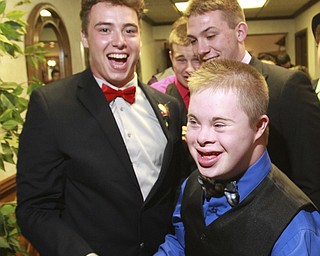 William D. Lewis the Vindicator  Special needs prom guest Thomas Beck of Canfield, center, shares a moment with Canfield HSseniors Dylan Kuhn, left, and Mike Yourstowski during special needs prom Friday 5-8 at St. Mary's in youngstown.