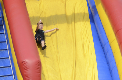 Katie Rickman | The Vindicator.Kaleb Votaw 8 of Salem throws his hands in the air as he excitedly slides down a bounce house slide at the 5th annual Carnival  at Damascus Elementary School on May 9, 2015.