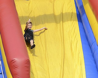 Katie Rickman | The Vindicator.Kaleb Votaw 8 of Salem throws his hands in the air as he excitedly slides down a bounce house slide at the 5th annual Carnival  at Damascus Elementary School on May 9, 2015.