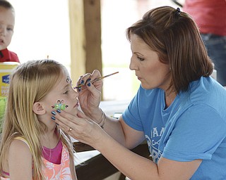 Katie Rickman | The Vindicator.Vicki Robertson of Salem paints the face of Christina Mutton 7 of Salem at the 5th annual Carnival  at Damascus Elementary School on May 9, 2015.