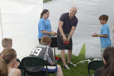 Katie Rickman | The Vindicator.Jennifer Phillis 11 of Beloit on left and Matthew Baird 9 of Salem on right assist magician Jason Alan during a magic show at the 5th annual Carnival  at Damascus Elementary School on May 9, 2015.